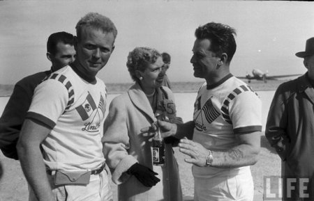 Life magazine vintage men talking on airport tarmac.