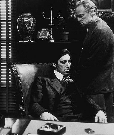 Godfather movie Marlon Brando Pacino sitting on chair.