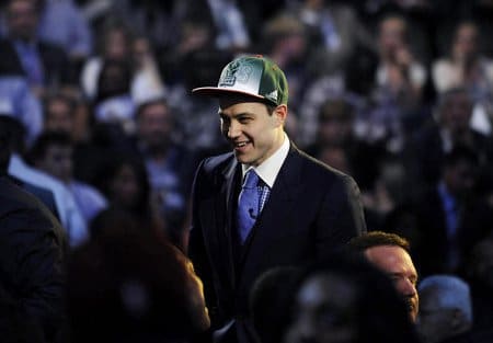 James Fredette wwearing hat and smiling in the NBA draft by the Sacramento Kings.