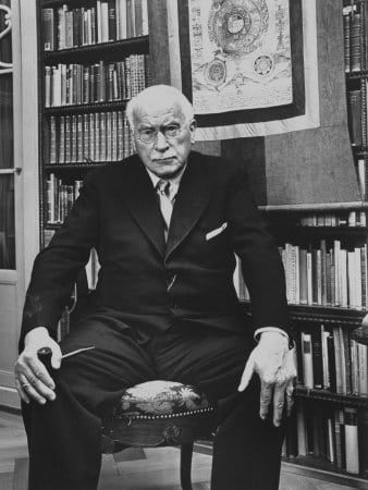 Psychologist Carl Jung sitting on the chair in his office.