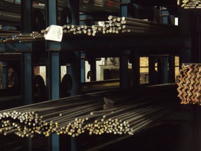 Steel rods on shelves for blacksmith supplies.