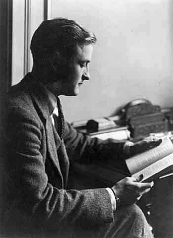 Young F Scott Fitzgerald reading book in the office.