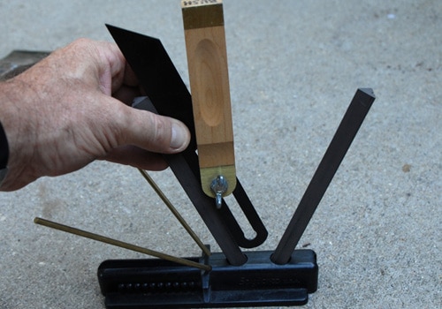 Measuring testing angle of triangle tool sharpener.