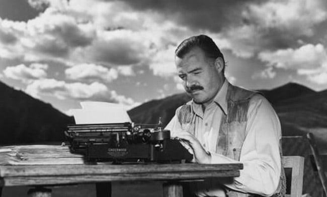 Ernest Hemingway working on typewriter.