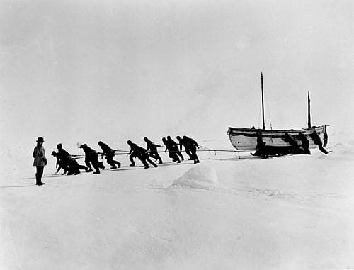 The men attempting to pull the boats across the ice floes.