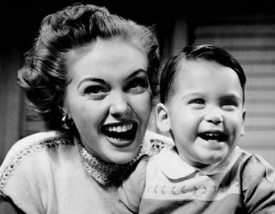 Vintage young boy smiling with his mom.