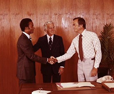 Vintage businessmen are shaking hands while making a deal.