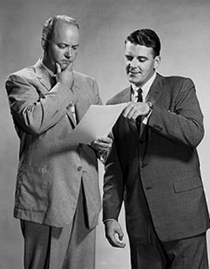 vintage businessmen pondering looking at papers