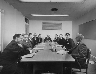 Vintage businessmen at conference table for meeting.