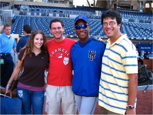 rickyhenderson Ricky Henderson mets posing with fans on baseball field