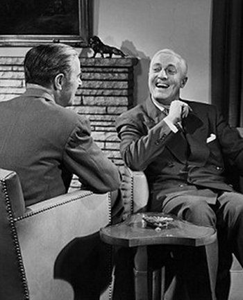 vintage men talking laughing across from each other