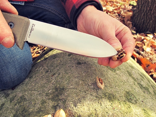 A man using a single-Edged Blade with Flat Ground Spine.