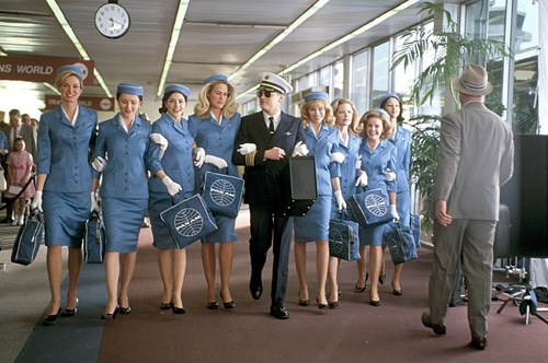 Leonardo Dicaprio walking down at airport with airhostess women staff.