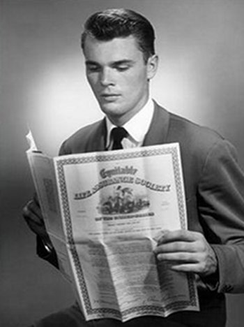 Young man in suit reading the insurance paper.