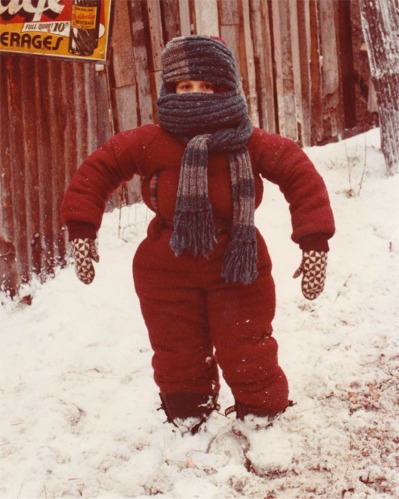 Little boy in red snow suit.