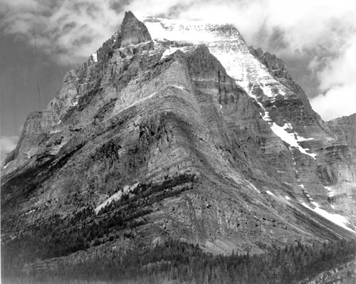 Black & white photo of Ansel Adams mountains covered with snow.