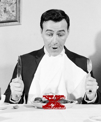 Vintage man with big plate of food in front at table.