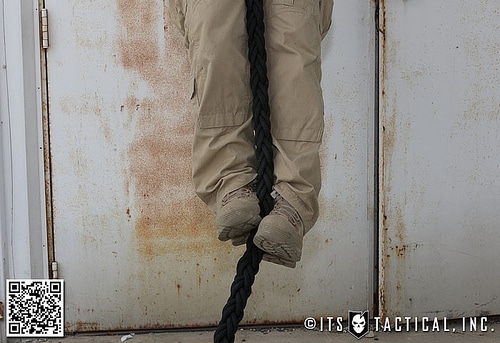 A man climbing rope foot shoot.