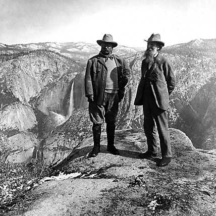 Teddy Roosevelt in Yellowstone canyon posing on rock.