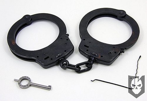 Pair of black handcuffs with key and pick. 