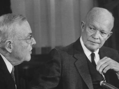 Eisenhower older looking man in the eye while speaking.