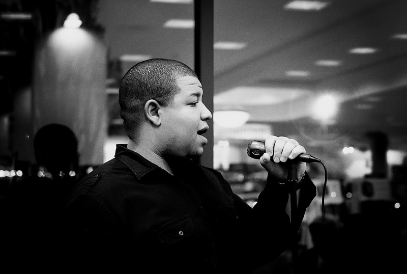 Jordan Chaney singing on stage with microphone.