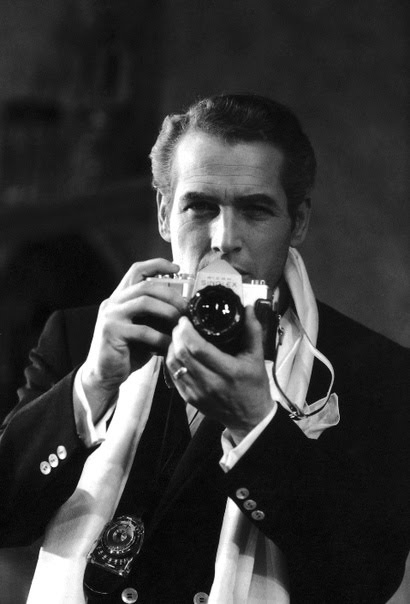 Vintage man with camera and wearing scarf and blazer.