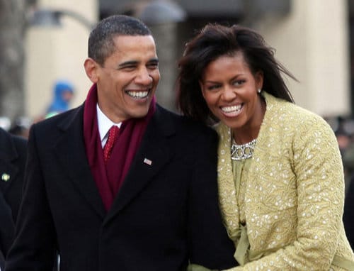 Barack Obama wearing red scarf with Michelle.