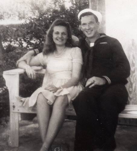 Vintage couple sitting on bench.