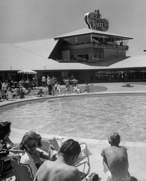 Vintage people enjoying at desert inn pool area. 