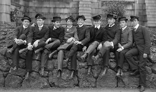 Group of guys posing on stone wall portrait. 