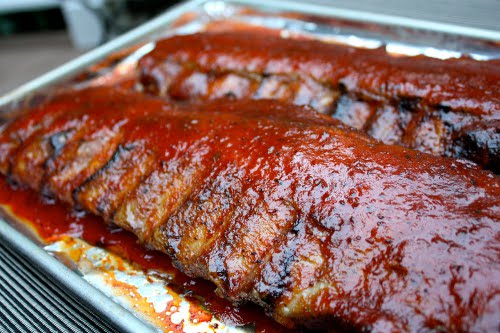 Vintage oven grilling baby back BBQ ribs.