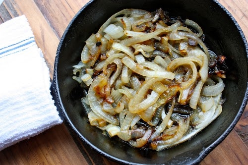Vintage caramelizing onions in skillet.