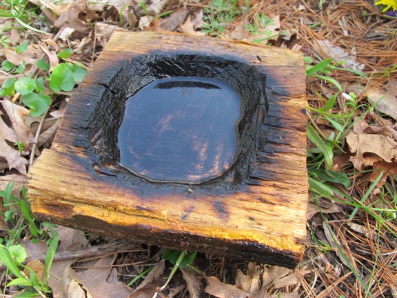 Vintage coal burning containers placed on earth.