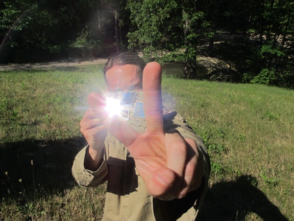 Vintage man capturing a shoot of two fingers with mobile camera.