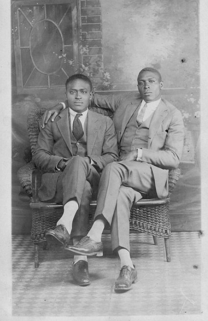Vintage two men sitting on chair black and white photo illustration.