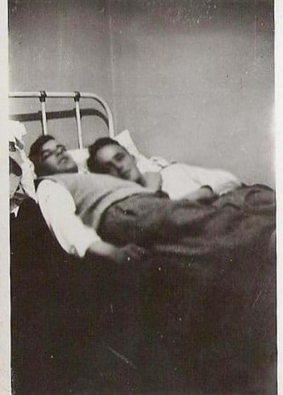 Vintage two young men sleeping on the bed black and white illustration.