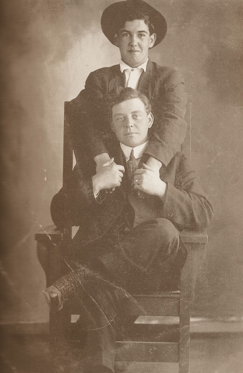 Vintage two men sitting and holding hands each other black and white photo illustration.