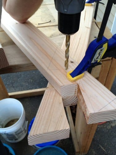 DIY homemade wooden sawhorse drilling carriage bolt.