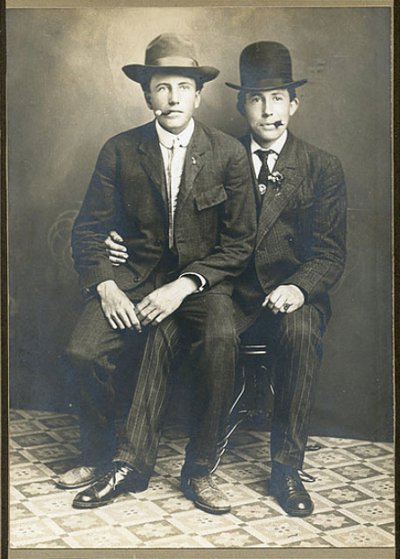 Vintage two men sitting on chair and smoking cigarette black and white photo illustration.