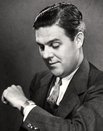 Vintage man businessman looking down at watch.