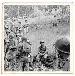 Sid Phillips WWII soldier looking at troops.