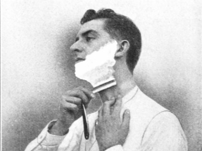 Vintage man shaving neck with straight razor grainy.