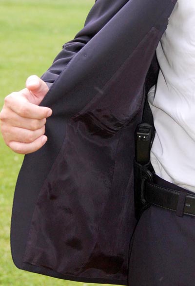 Concealed carry style blazer handgun showing jacket open.