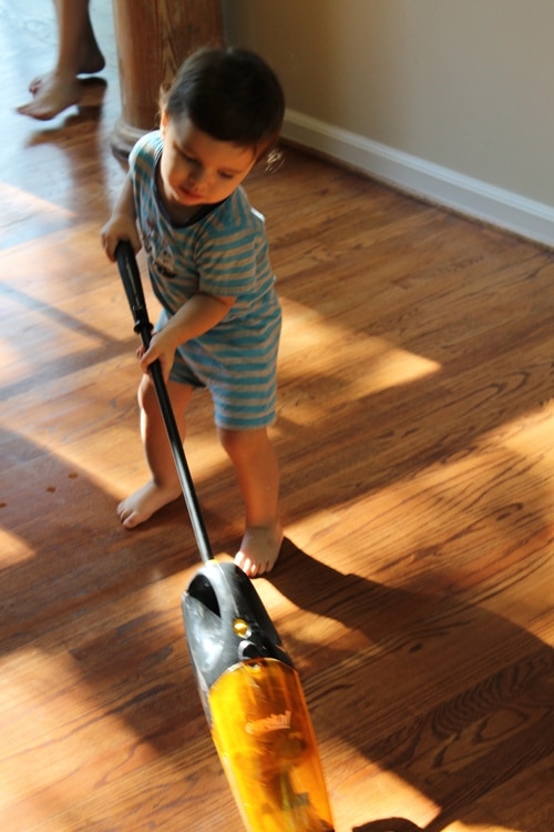 IMG_1058 young boy doing chores vacuuming floor