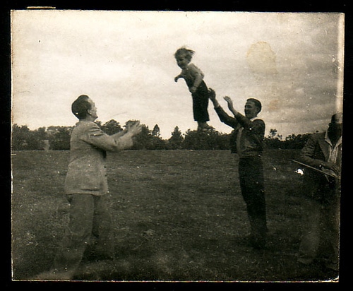 toss vintage men tossing young boy between them