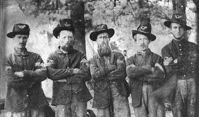 Union army soldiers of civil war in uniforms looking gruff. 