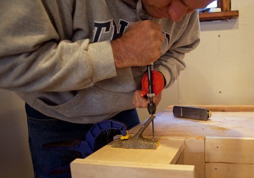 diy homemade coat hook from tree branch drilling hole to mount