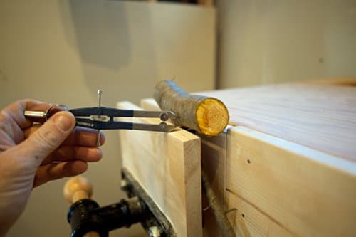diy homemade coat hook from tree branch marking backside for cut