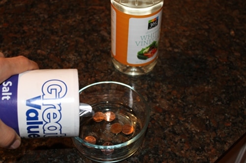 salt in dish with vinegar and salt cleaning coins